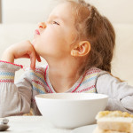 little girl turning away from food