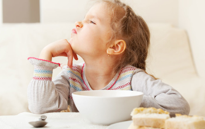 little girl turning away from food