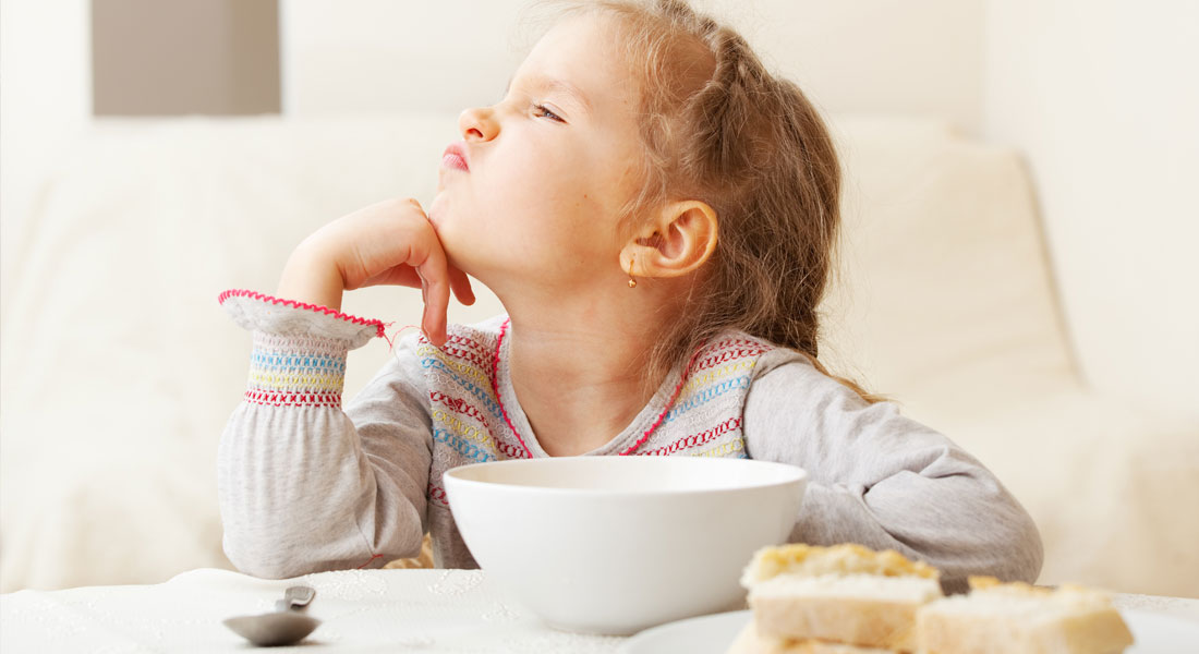 little girl turning away from food