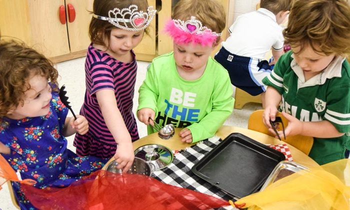 preschoolers playing with kitchen utensils