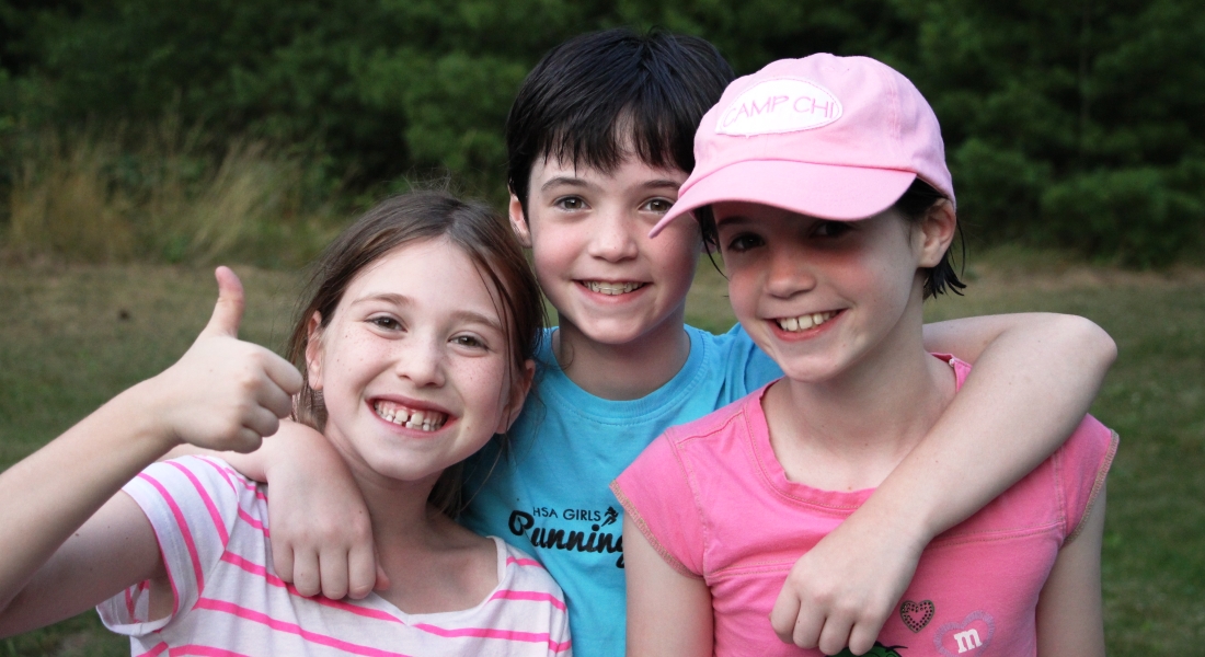 one boy and two girl campers smiling for photo