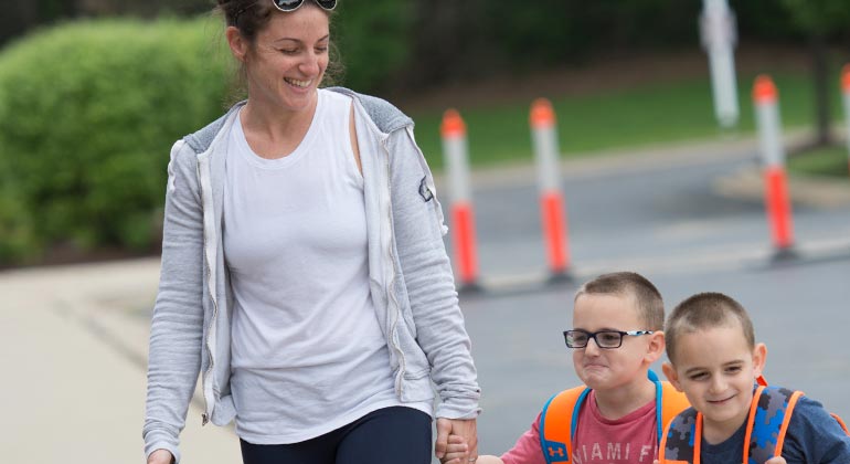 mom dropping off boys at preschool