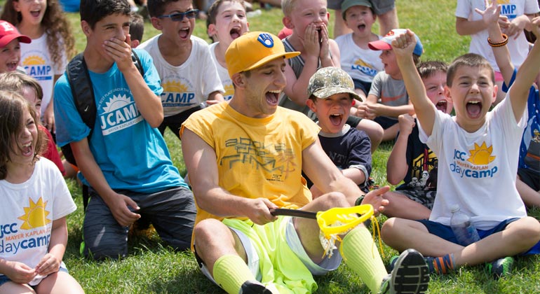 counselors and campers cheering and smiling