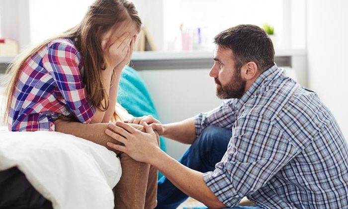 dad comforting upset daughter