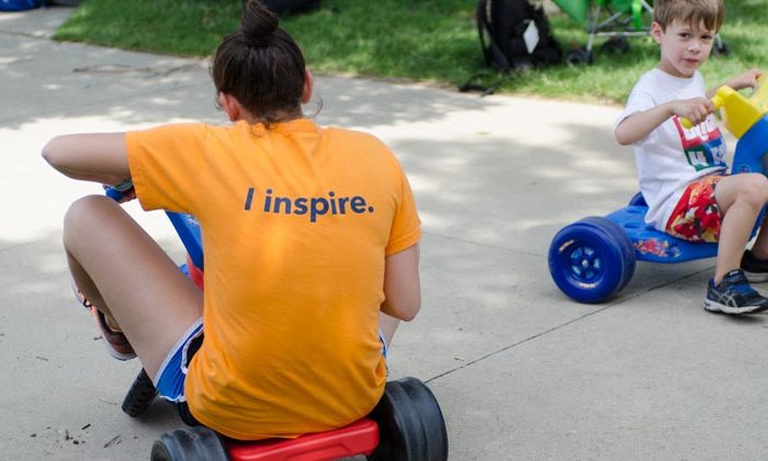 apachi counselor and camper riding tricycles