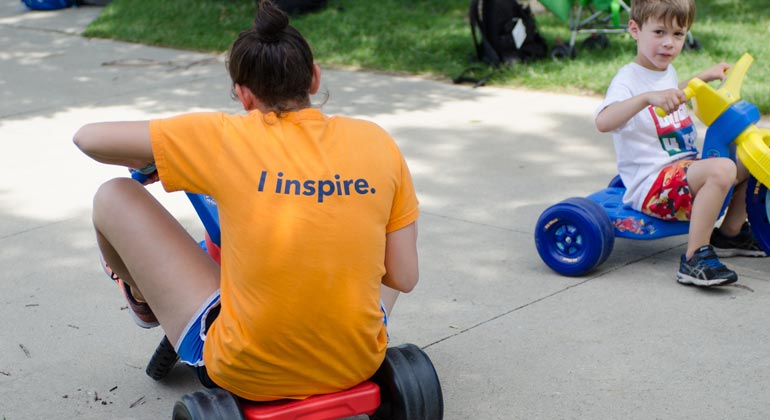 apachi counselor and camper riding tricycles