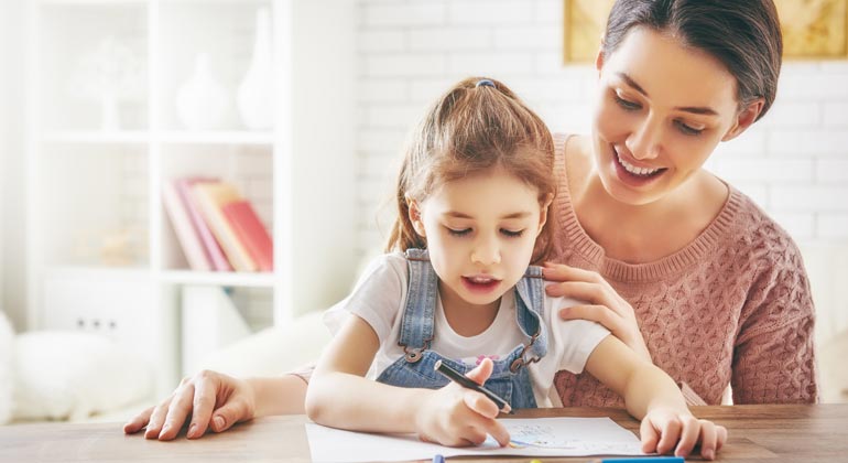 mom helping daughter color