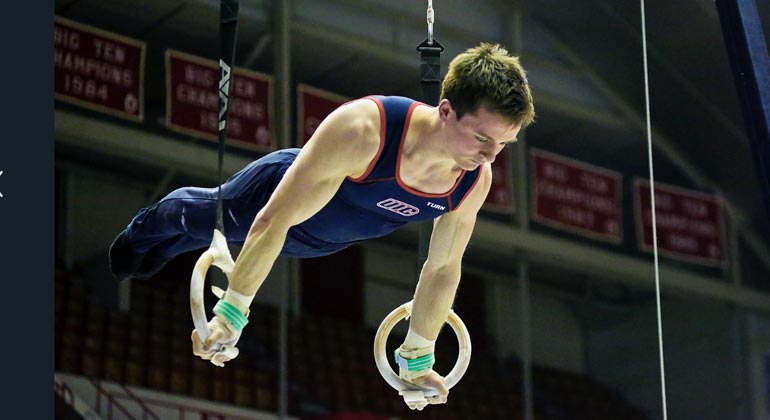 male gymnast on rings