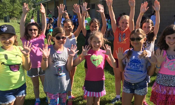 elaine frank apachi campers holding up 10 fingers for camp's 10th anniversary