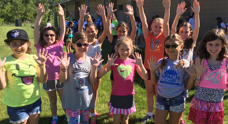 elaine frank apachi campers holding up 10 fingers for camp's 10th anniversary