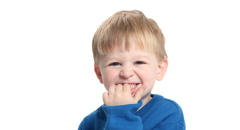 young boy biting nails