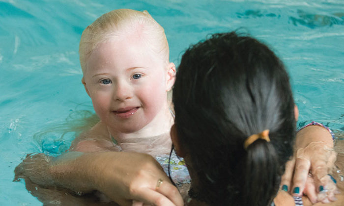 young boy swimming in pool