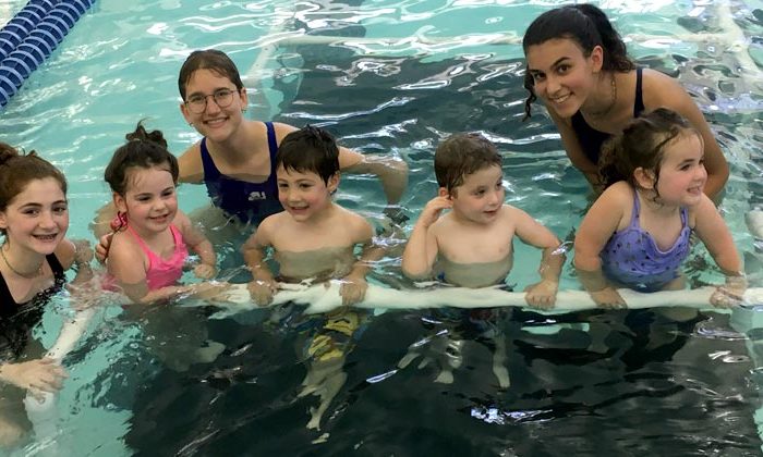 swim instructors with kids in pool