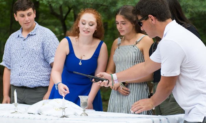 teenagers lighting shabbat candles together