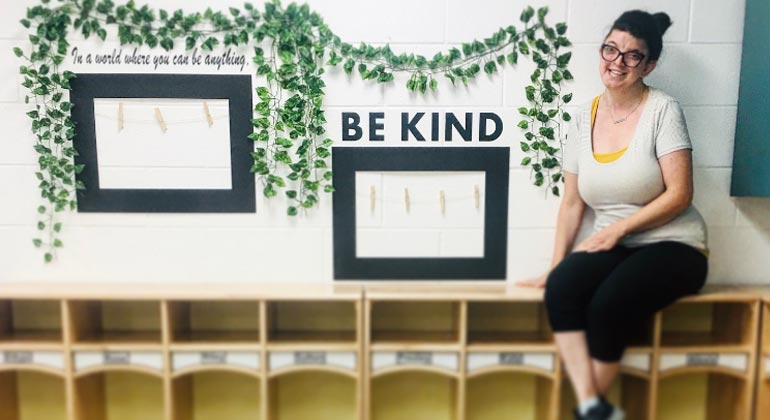 rena rosen in front of sign that reads "be kind"