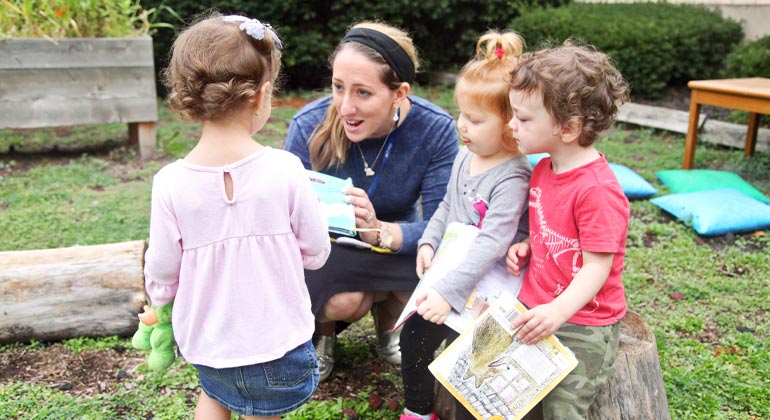 teacher teaching hebrew to preschool girls