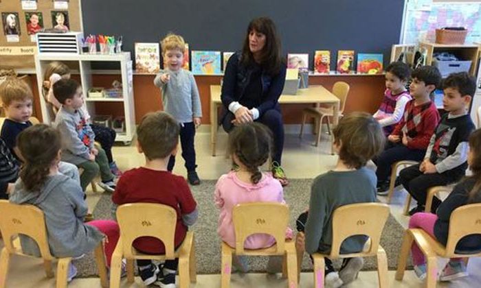 children in classroom watching presentation