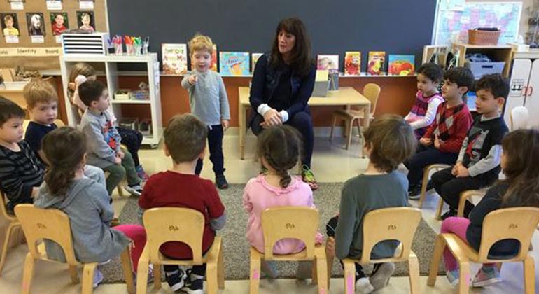 children in classroom watching presentation