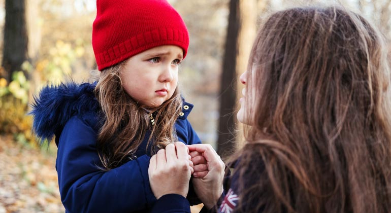 mom talking to upset daughter