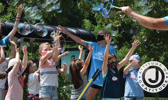 Campers and counselors playing with bubbles