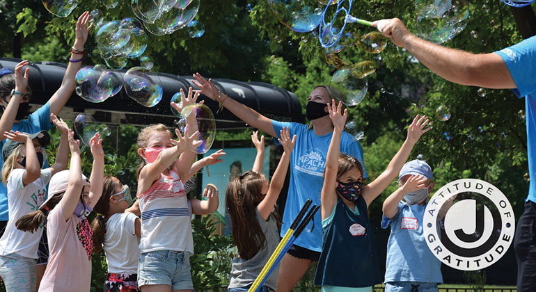 Campers and counselors playing with bubbles