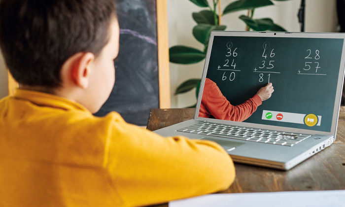 boy at computer doing online math lesson