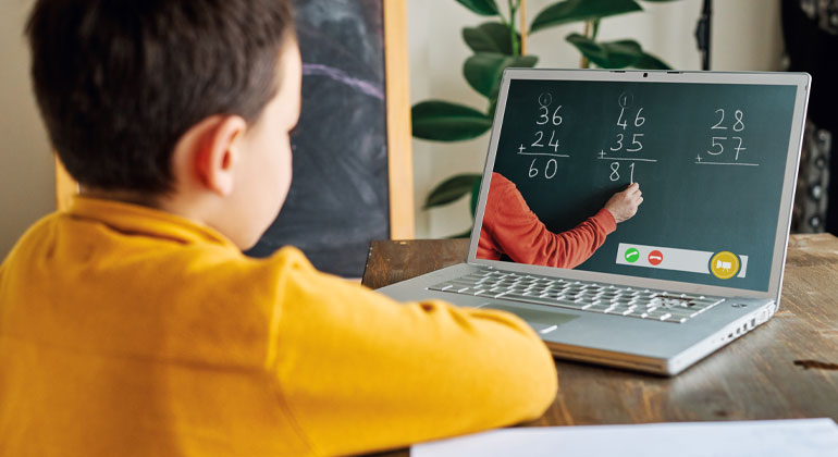 boy at computer doing online math lesson