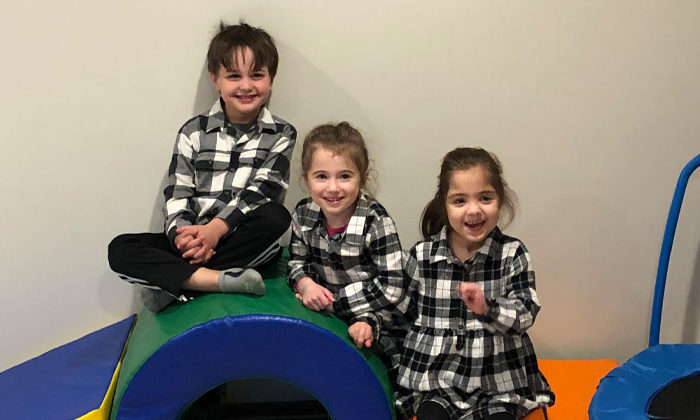 three early childhood students in matching flannel outfits