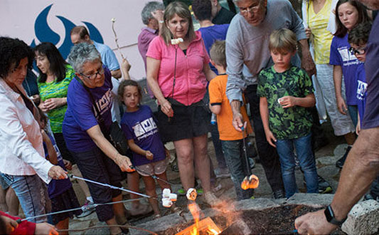 grandparents and grandchildren roasting marshmallows